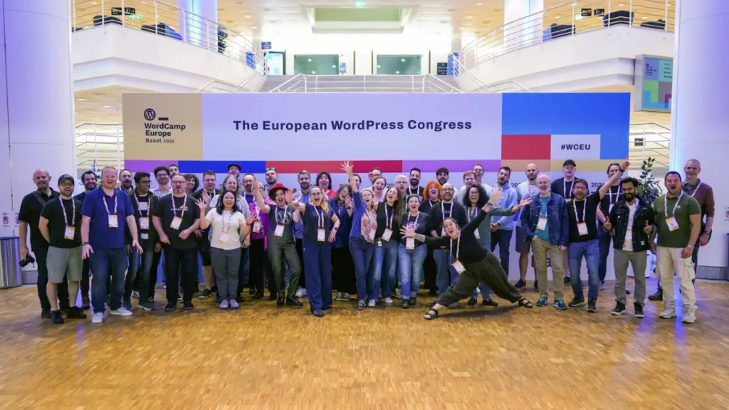 Group photo of organisers in front of the design board. Photo by Nilo Velez