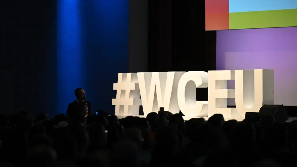 WordCamp Europe hashtag letters on stage. Photo by Kostas Fryganiotis